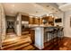 Modern kitchen with hardwood floors, stainless steel appliances and granite countertops with bar stool seating at 333 Massachusetts Ave # 204, Indianapolis, IN 46204
