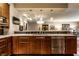 Stylish kitchen features granite counters, stainless steel appliances, wood cabinets and hardwood floors at 333 Massachusetts Ave # 204, Indianapolis, IN 46204