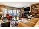 Cozy living room with a fireplace, balcony access, comfortable seating, and stylish decor at 333 Massachusetts Ave # 204, Indianapolis, IN 46204