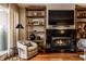 Cozy living room corner with a comfortable chair, fireplace, and built-in shelving at 333 Massachusetts Ave # 204, Indianapolis, IN 46204
