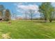 Expansive backyard featuring a large grassy area, mature trees, and potential for outdoor activities and relaxation at 3362 E Sycamore Ln, Mooresville, IN 46158