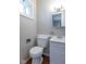A bathroom with a toilet, sink and vanity with bright lighting at 3362 E Sycamore Ln, Mooresville, IN 46158