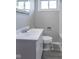 Bright bathroom with a white sink vanity, matching toilet, and a modern mirror at 3362 E Sycamore Ln, Mooresville, IN 46158