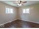 A bedroom with hardwood floors, ceiling fan and two large windows at 3362 E Sycamore Ln, Mooresville, IN 46158