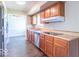 Functional kitchen with stainless steel appliances, wooden cabinetry, and view to eat in area, ready for meal preparation at 3362 E Sycamore Ln, Mooresville, IN 46158
