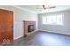 Cozy living room featuring dark floors, a brick fireplace, and a ceiling fan at 3362 E Sycamore Ln, Mooresville, IN 46158
