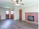 Open living space with dark floors, brick fireplace, and multiple entry points at 3362 E Sycamore Ln, Mooresville, IN 46158