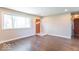 Bright living room featuring hardwood floors, a front door, and a large picture window at 3362 E Sycamore Ln, Mooresville, IN 46158