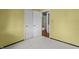 This bedroom has light walls, neutral carpet, and double closets at 3561 Winings Ave, Indianapolis, IN 46221