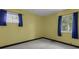 This bedroom has light walls, neutral carpet, and two windows with drapes at 3561 Winings Ave, Indianapolis, IN 46221
