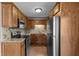 Well-lit kitchen featuring stainless steel appliances, wood cabinets, and light countertops at 3561 Winings Ave, Indianapolis, IN 46221