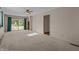 The Living room has neutral paint, carpet, and a sliding glass door to the yard at 3561 Winings Ave, Indianapolis, IN 46221