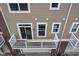 Townhome backyard with sliding glass door, small balcony, and outdoor storage unit at 360 Neuman Way, Carmel, IN 46032