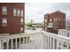 View from a balcony showing brick buildings, a fountain, and a residential street at 360 Neuman Way, Carmel, IN 46032