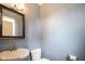 Powder room with soft blue walls, mirror and toilet at 360 Neuman Way, Carmel, IN 46032