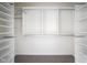 Walk-in closet featuring custom shelving and carpeted floor at 360 Neuman Way, Carmel, IN 46032