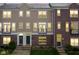 Inviting townhome featuring a mix of brick and siding, complemented by black trim and a charming balcony at 360 Neuman Way, Carmel, IN 46032