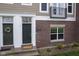 Charming townhome entrance featuring a decorative wreath, with a mix of brick and siding at 360 Neuman Way, Carmel, IN 46032