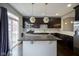 View of a kitchen with a stone island, stainless steel appliances, and dark cabinets at 360 Neuman Way, Carmel, IN 46032