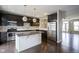 Kitchen with a stone island, stainless steel appliances, and dark cabinets at 360 Neuman Way, Carmel, IN 46032