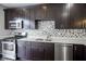 Modern kitchen with stainless steel appliances, tile backsplash and dark brown cabinets at 360 Neuman Way, Carmel, IN 46032