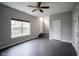 Modern living room with dark wood floors, a large window, and neutral gray walls at 360 Neuman Way, Carmel, IN 46032