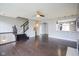 Spacious living room featuring dark hardwood floors, staircase and a ceiling fan above at 360 Neuman Way, Carmel, IN 46032