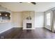 Bright living room featuring a fireplace, dark floors, and an open layout connected to the kitchen at 360 Neuman Way, Carmel, IN 46032
