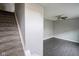 Carpeted staircase leading to a minimalist room with a ceiling fan and dark flooring at 360 Neuman Way, Carmel, IN 46032