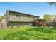 Spacious backyard featuring a well-maintained lawn, wooden deck, and mature landscaping at 3615 Dawnwood Dr, Indianapolis, IN 46227