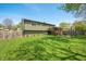 Expansive backyard with lush green lawn, deck, mature trees, and stylish outdoor seating at 3615 Dawnwood Dr, Indianapolis, IN 46227