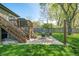 Backyard features a patio area for outdoor gatherings, a grill, and a deck with stairs to the yard at 3615 Dawnwood Dr, Indianapolis, IN 46227