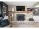 Spacious basement entertainment area with a brick fireplace, mounted TVs, and modern decor at 3615 Dawnwood Dr, Indianapolis, IN 46227