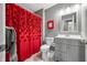 Bathroom with modern vanity, mirror, toilet, and shower with unique red floral curtain at 3615 Dawnwood Dr, Indianapolis, IN 46227