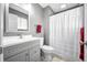 Bathroom with a modern vanity, toilet, and shower with a white shower curtain at 3615 Dawnwood Dr, Indianapolis, IN 46227