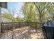 Wooden deck offers outdoor living space with ample room for grilling and dining surrounded by green trees at 3615 Dawnwood Dr, Indianapolis, IN 46227