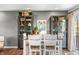 Dining area with views, modern decor, bar cabinets, a dining table, and access to outdoor spaces at 3615 Dawnwood Dr, Indianapolis, IN 46227