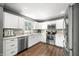 Modern kitchen with stainless steel appliances, white cabinets, and granite countertops at 3615 Dawnwood Dr, Indianapolis, IN 46227