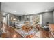 Open-concept living room featuring hardwood floors, comfortable seating, and abundant natural light at 3615 Dawnwood Dr, Indianapolis, IN 46227