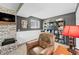 Cozy living room with fireplace, comfortable recliner, bookshelves, and ample lighting at 3615 Dawnwood Dr, Indianapolis, IN 46227