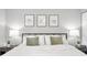 Relaxing primary bedroom featuring a cozy bed with decorative pillows and stylish lamps at 3615 Dawnwood Dr, Indianapolis, IN 46227