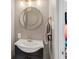 Charming powder room with a round mirror, modern sink, vanity and neutral color palette at 3615 Dawnwood Dr, Indianapolis, IN 46227