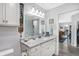 Well-lit bathroom with granite countertops, white cabinets, decorative accents, and easy access to other rooms at 400 E Charter Dr, Muncie, IN 47303
