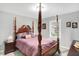 Bedroom with a grand four-poster bed, neutral walls, and natural light from a window at 400 E Charter Dr, Muncie, IN 47303