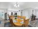 Cozy dining room featuring a large wooden table, modern lighting, and a leafy plant at 400 E Charter Dr, Muncie, IN 47303