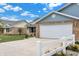 Attractive home exterior with a two-car garage, nice lawn, and well-kept flower beds at 400 E Charter Dr, Muncie, IN 47303