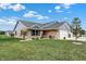 Attractive brick home with a well-maintained lawn, lovely landscaping, and a two-car garage at 400 E Charter Dr, Muncie, IN 47303