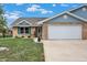 Charming brick home featuring a well-manicured lawn and a two-car attached garage at 400 E Charter Dr, Muncie, IN 47303