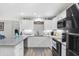 Bright kitchen with white cabinets, granite countertops, and stainless steel appliances at 400 E Charter Dr, Muncie, IN 47303
