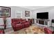 Cozy living room has hardwood floors, entertainment center, and comfortable red leather seating at 400 E Charter Dr, Muncie, IN 47303